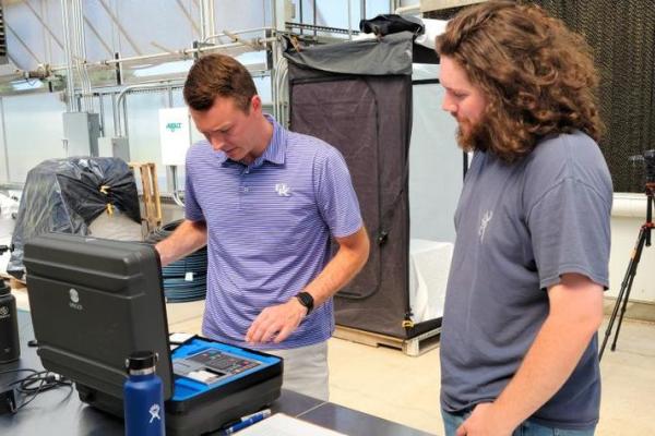 UK horticulture professor Garrett Owen works with UT plant science senior William Smith to study hydroponic lettuce at the UK Horticultural Research Farm