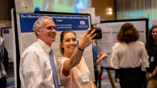 Jonathan Golding and undergraduate research mentee taking selfie at Showcase of Undergraduate Scholars