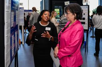 Yolanda Jackson, College of Communication and Information Ph.D. student, shares her Alzheimer’s screening research with NIH Director Monica Bertagnolli