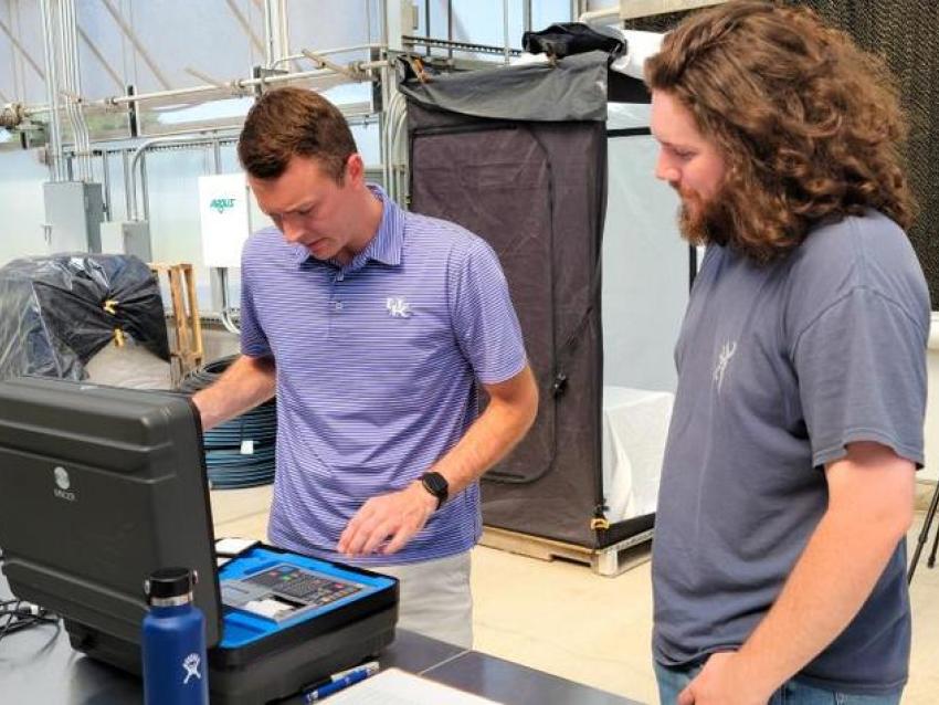 UK horticulture professor Garrett Owen works with UT plant science senior William Smith to study hydroponic lettuce at the UK Horticultural Research Farm